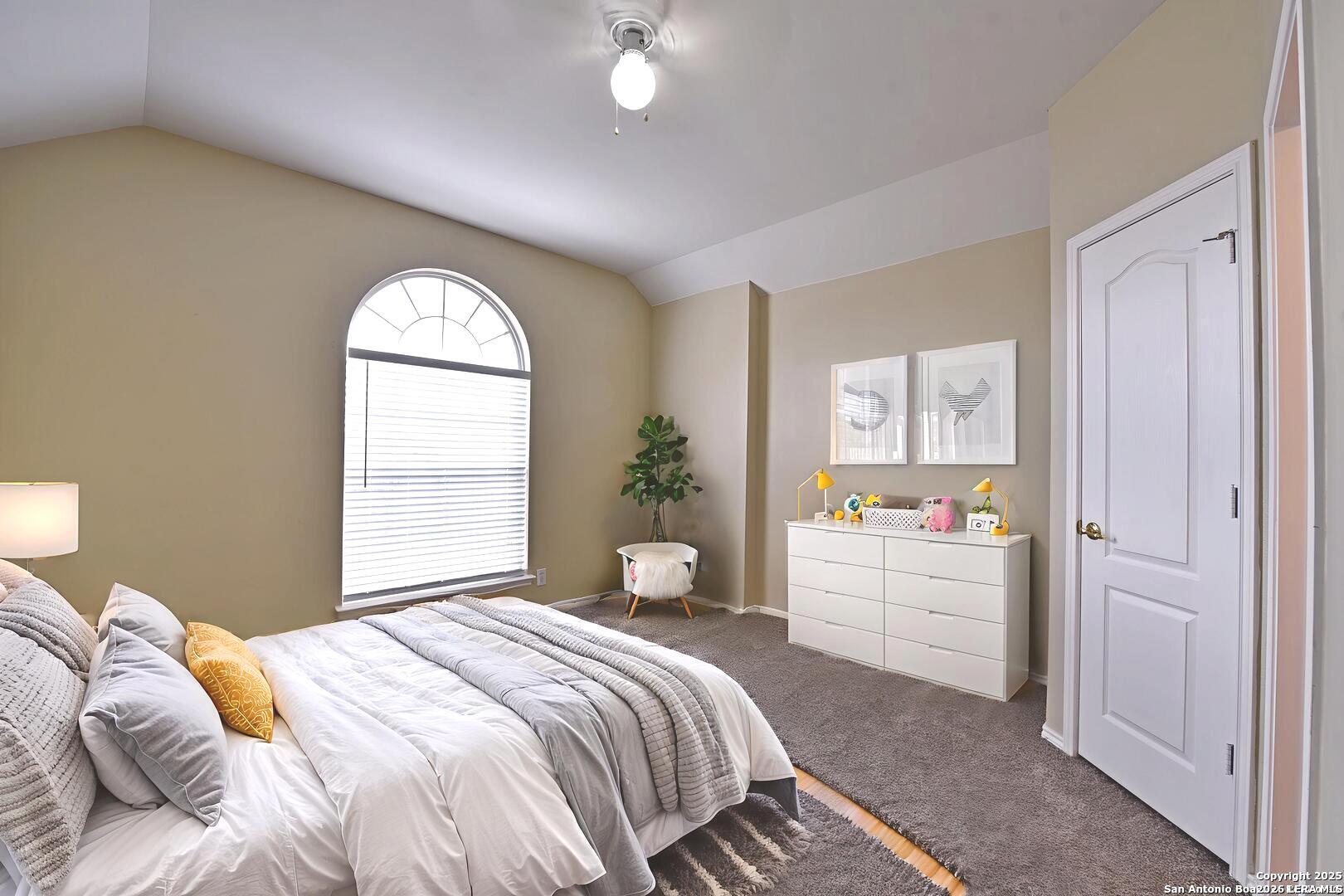 25303 Mesa Ranch San Antonio, TX 78258 - Photo 16 of 54 a bedroom with a bed and a window