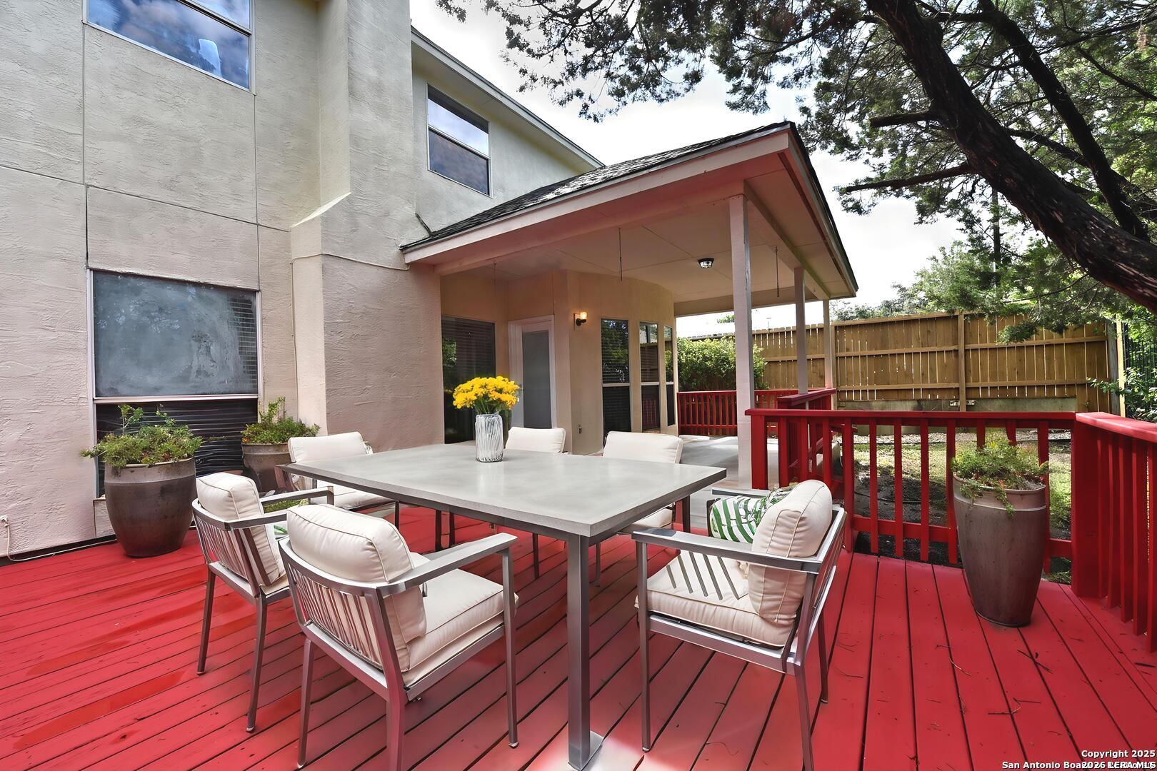 25303 Mesa Ranch San Antonio, TX 78258 - Photo 17 of 54 a view of a roof deck with dining table and chairs with wooden floor and fence