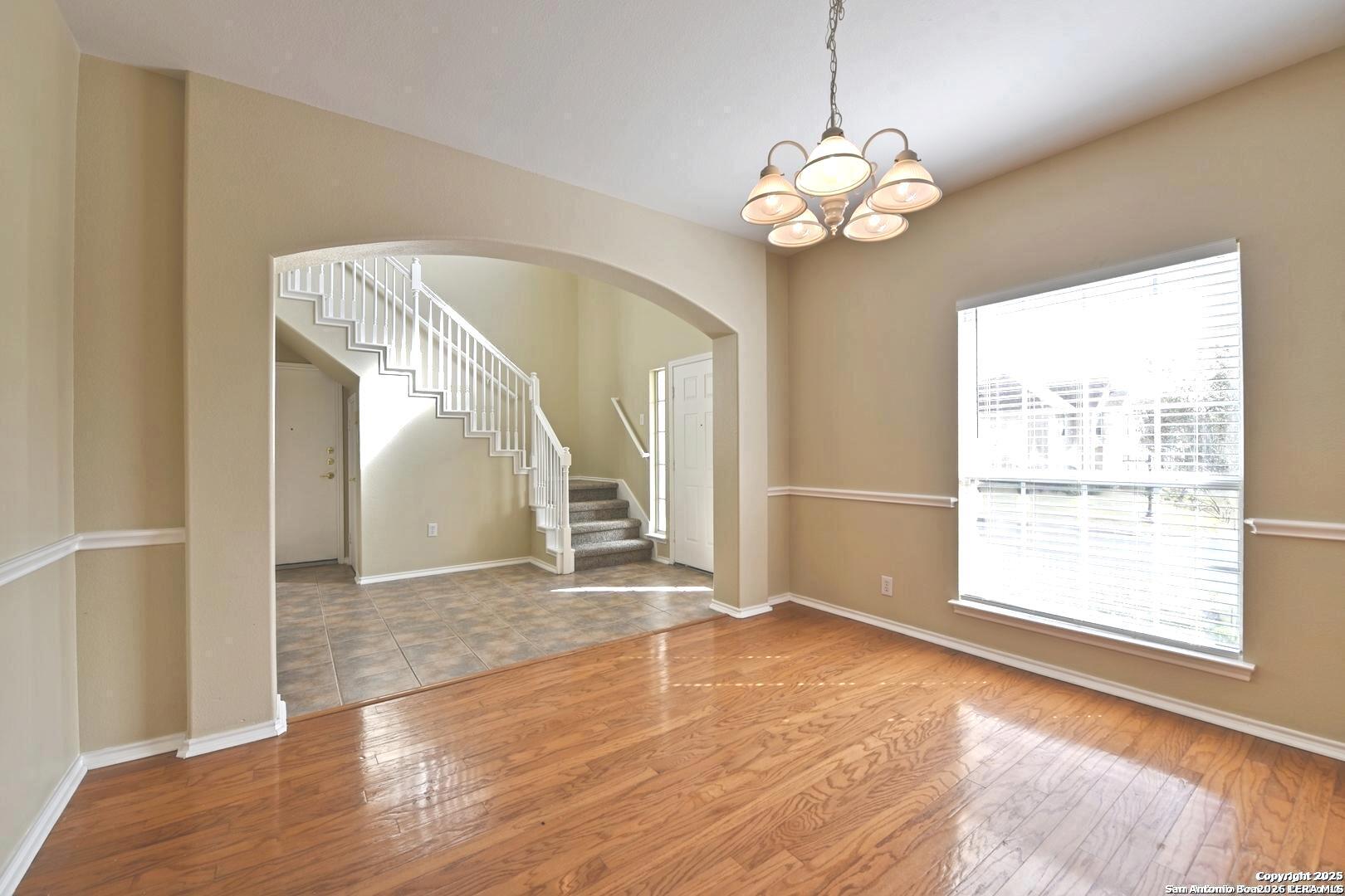 25303 Mesa Ranch San Antonio, TX 78258 - Photo 21 of 54 a view of an empty room with window and wooden floor
