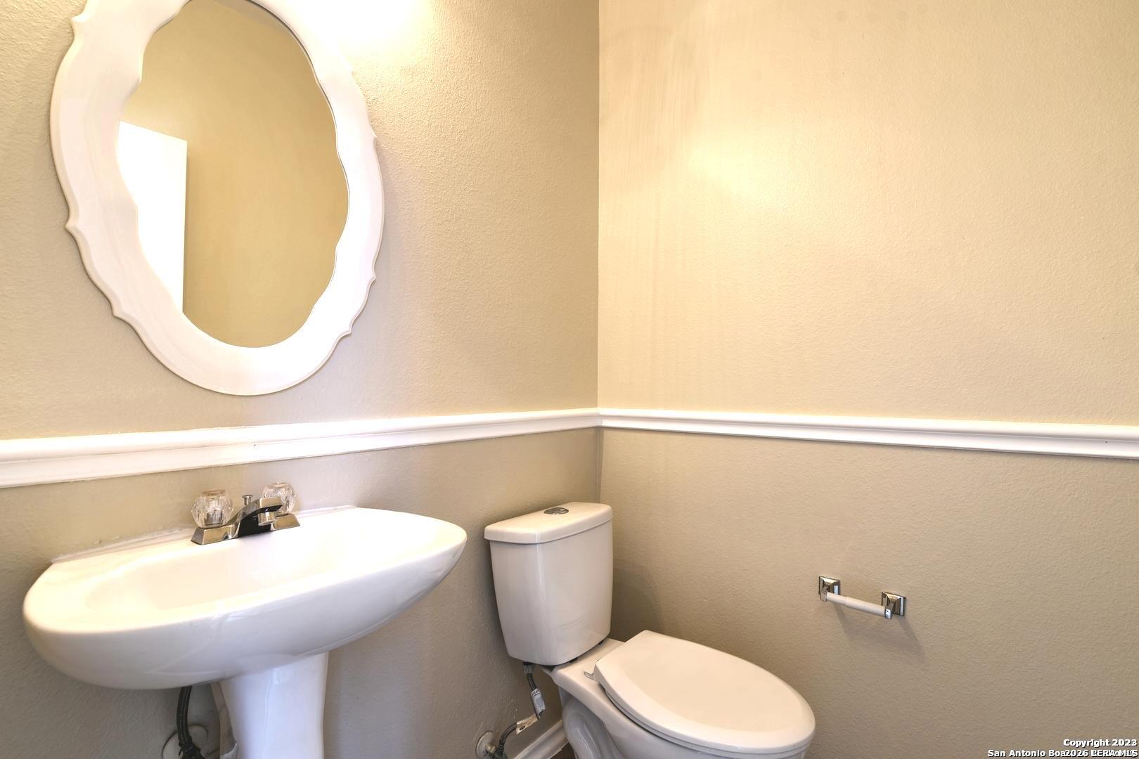 25303 Mesa Ranch San Antonio, TX 78258 - Photo 24 of 54 a bathroom with a sink mirror and toilet