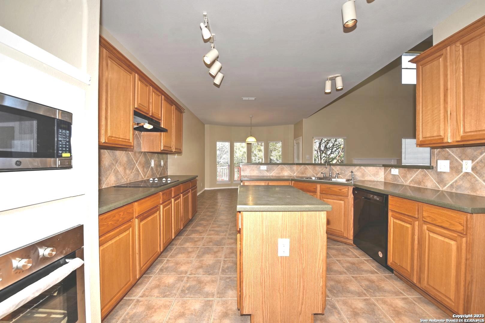 25303 Mesa Ranch San Antonio, TX 78258 - Photo 31 of 54 a kitchen with stainless steel appliances granite countertop a stove and a sink