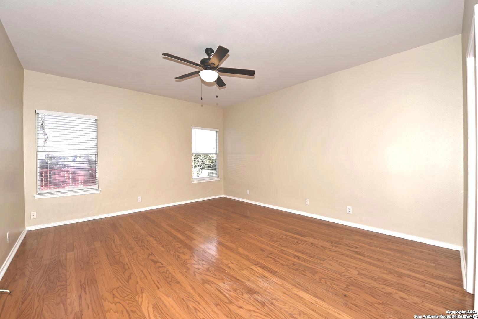 25303 Mesa Ranch San Antonio, TX 78258 - Photo 35 of 54 an empty room with wooden floor fan and windows