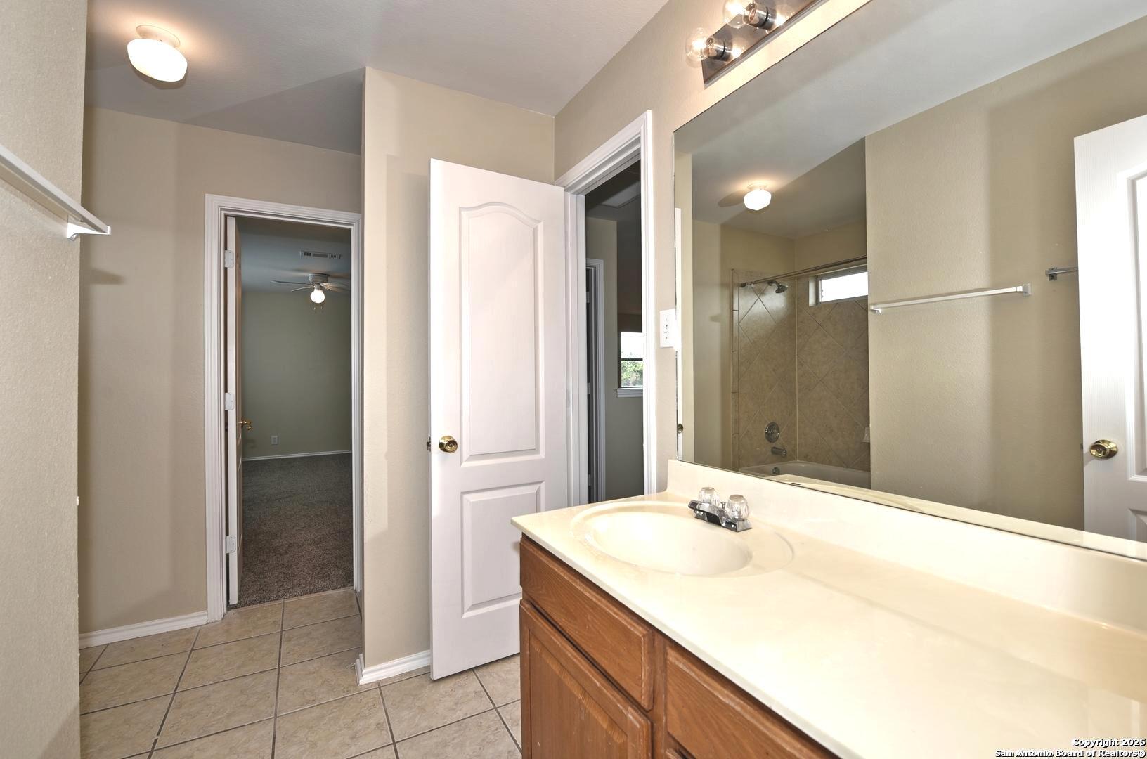 25303 Mesa Ranch San Antonio, TX 78258 - Photo 47 of 54 a bathroom with a sink and a mirror