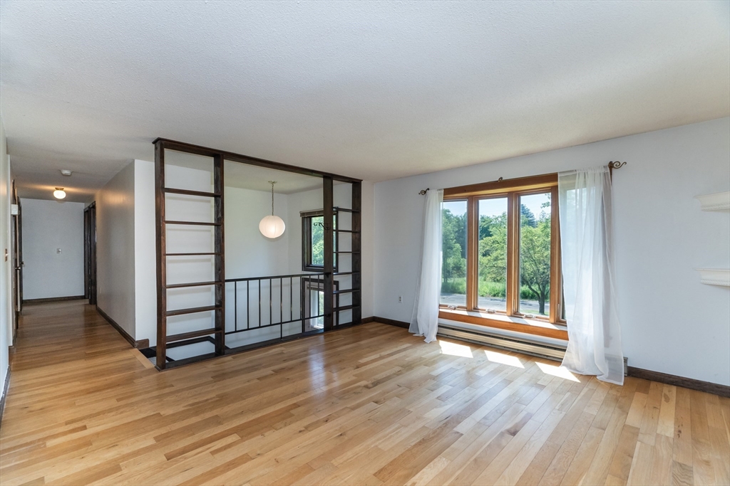 17 Pomeroy Court Amherst, MA 01002 - Photo 11 of 41 an empty room with wooden floor and windows