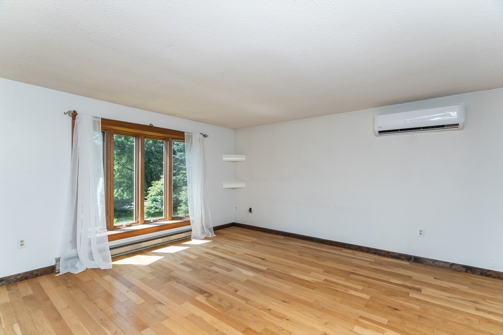 17 Pomeroy Court Amherst, MA 01002 - Photo 12 of 41 a view of an empty room with wooden floor and a window