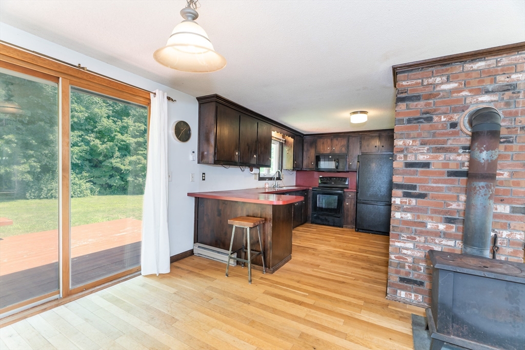 17 Pomeroy Court Amherst, MA 01002 - Photo 14 of 41 a kitchen with stainless steel appliances kitchen island granite countertop a refrigerator and a stove top oven