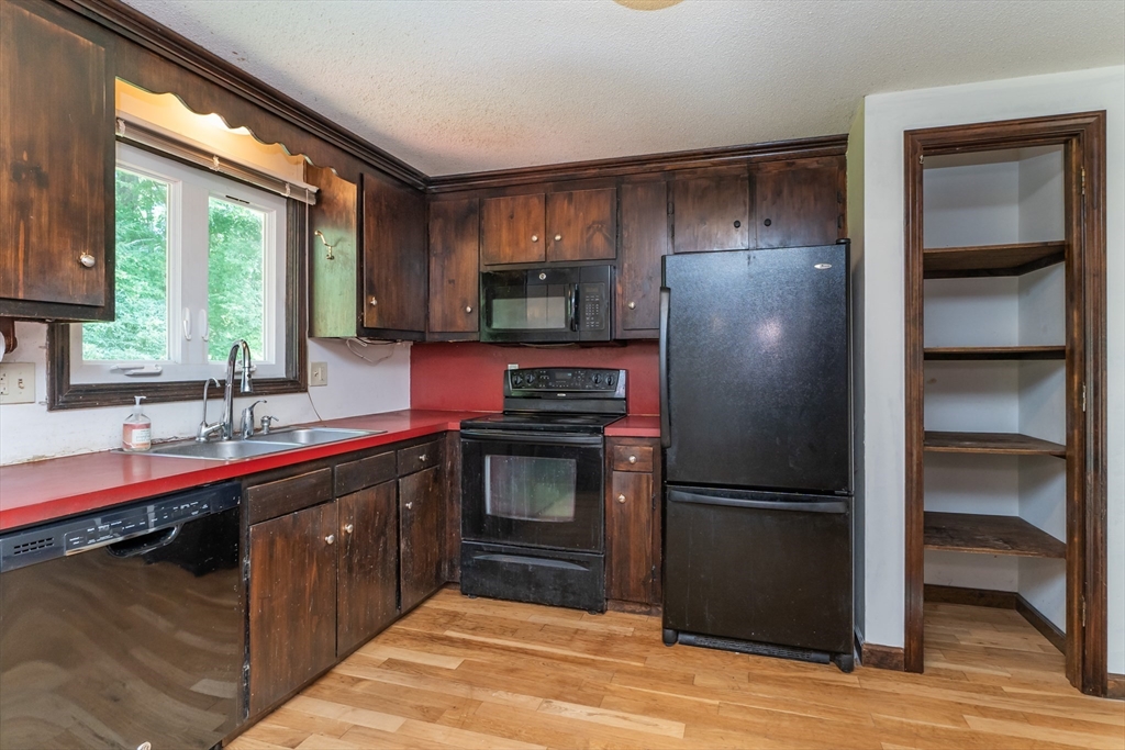 17 Pomeroy Court Amherst, MA 01002 - Photo 16 of 41 a kitchen with a refrigerator and a sink
