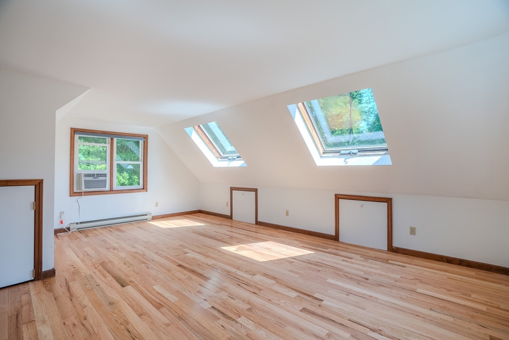 17 Pomeroy Court Amherst, MA 01002 - Photo 21 of 41 a view of an empty room with wooden floor and a window
