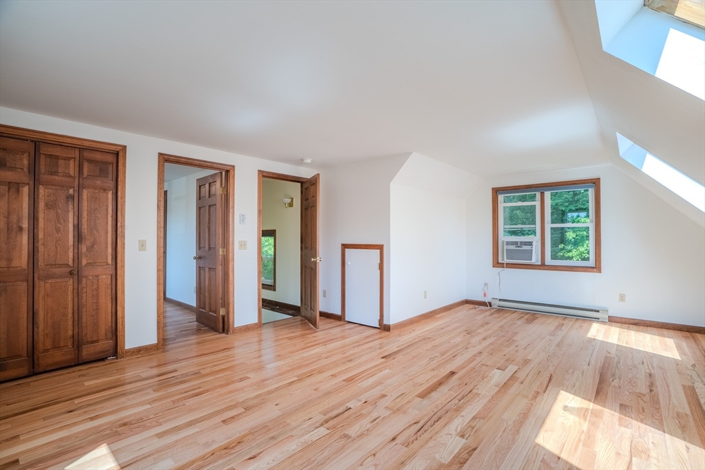 17 Pomeroy Court Amherst, MA 01002 - Photo 22 of 41 an empty room with wooden floor and windows