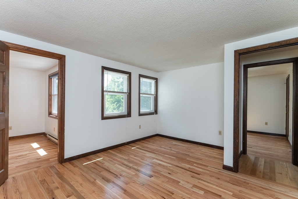 17 Pomeroy Court Amherst, MA 01002 - Photo 24 of 41 wooden floor in an empty room with a window