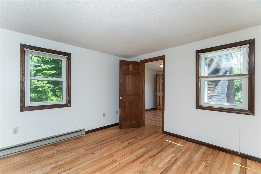 17 Pomeroy Court Amherst, MA 01002 - Photo 25 of 41 an empty room with wooden floor and windows
