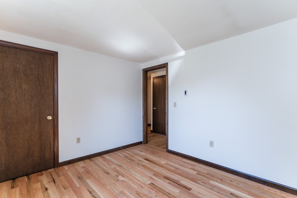 17 Pomeroy Court Amherst, MA 01002 - Photo 26 of 41 a view of an empty room with wooden floor