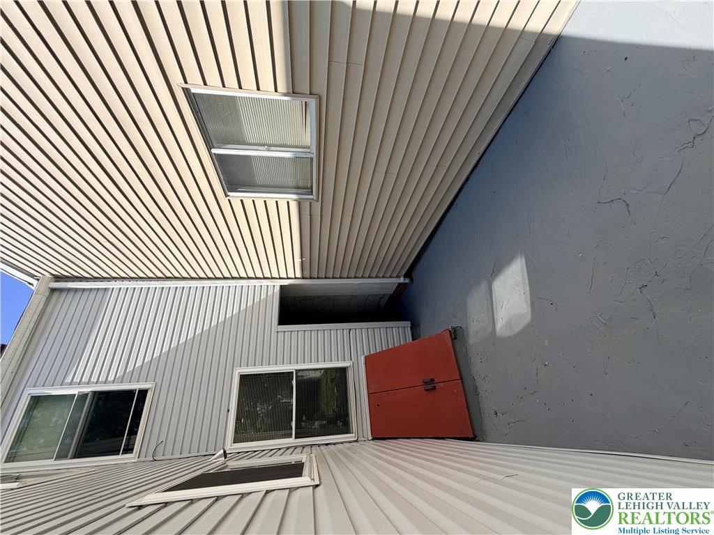 718 Ferry Street Easton, PA 18042 - Photo 31 of 37 Clean vinyl siding wraps around this residential building, presenting a neat facade with upper-level windows.