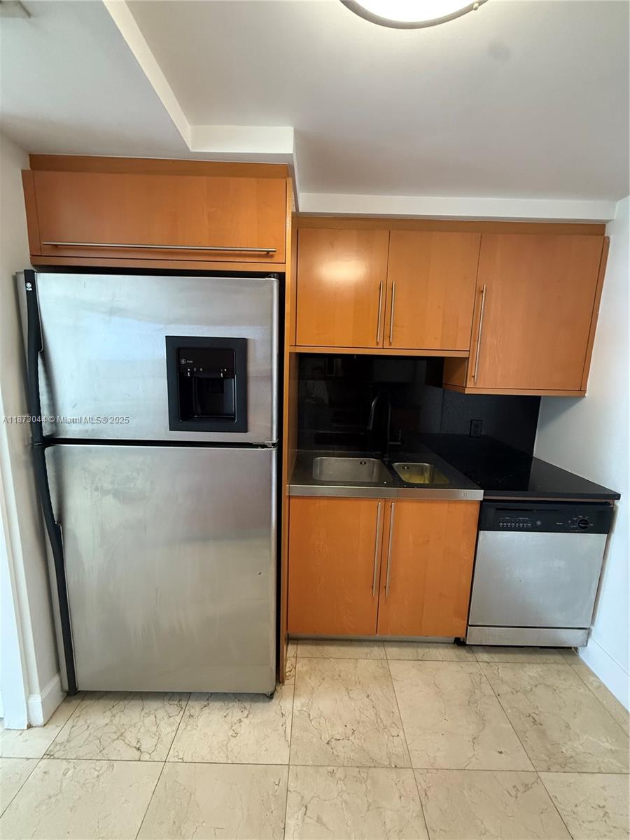 6365 Collins Avenue, Unit 904 Miami Beach, FL 33141 - Photo 12 of 25 a view of a living room with a refrigerator and a stove