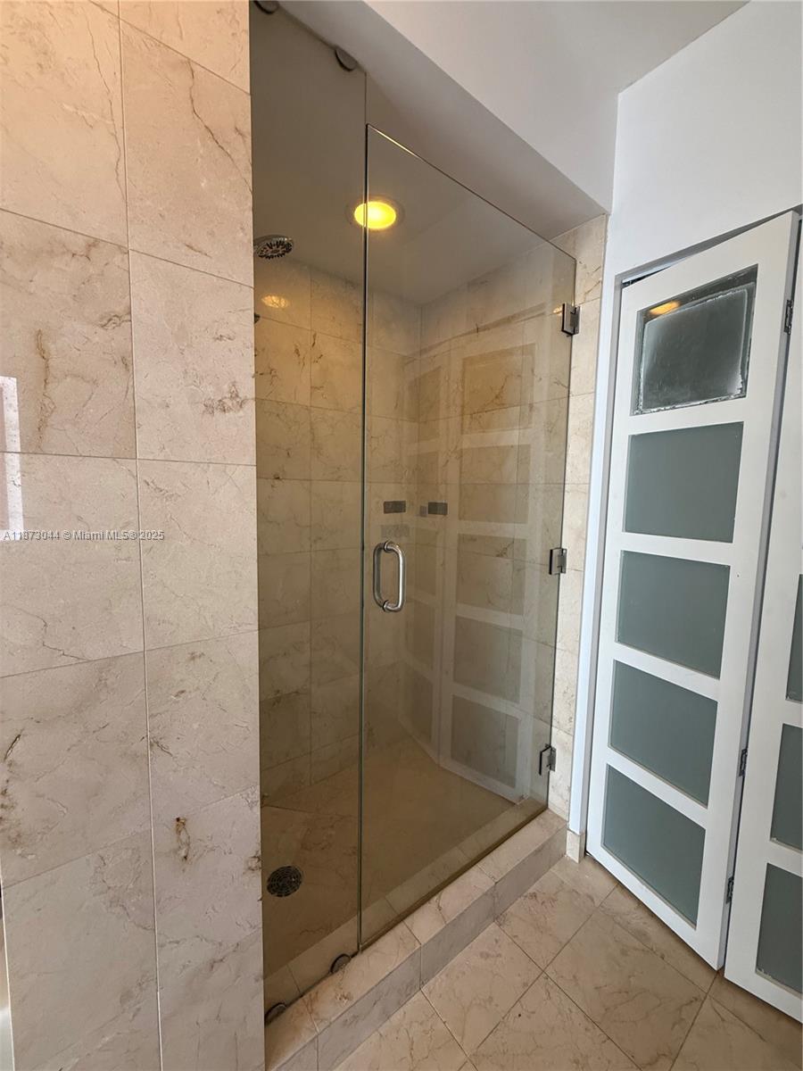 6365 Collins Avenue, Unit 904 Miami Beach, FL 33141 - Photo 15 of 25 a bathroom with a shower and a sink