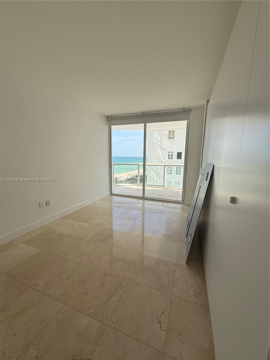 6365 Collins Avenue, Unit 904 Miami Beach, FL 33141 - Photo 18 of 25 an empty room with windows
