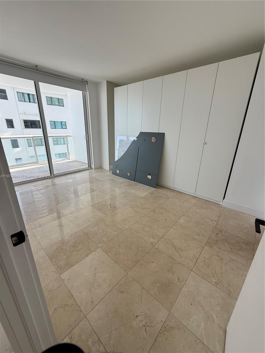 6365 Collins Avenue, Unit 904 Miami Beach, FL 33141 - Photo 20 of 25 a view of an empty room with a window