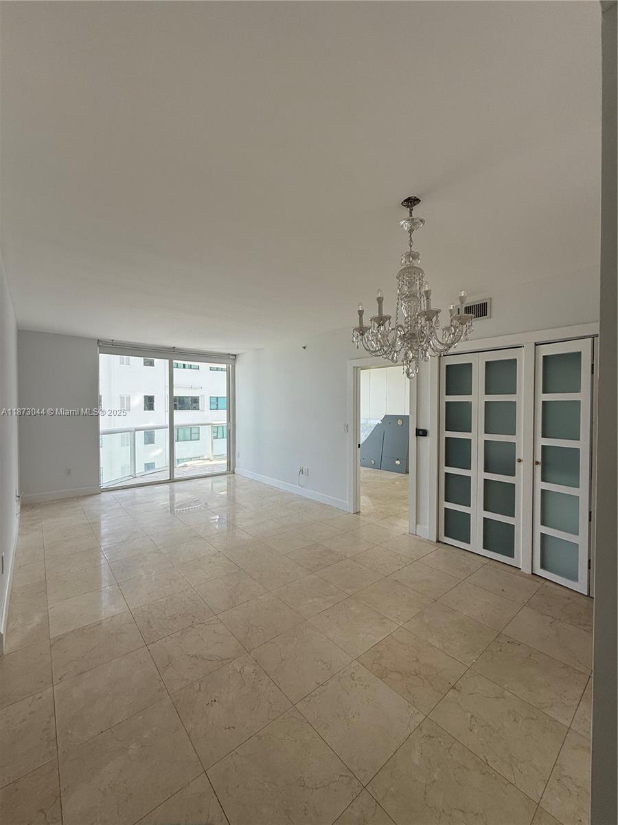 6365 Collins Avenue, Unit 904 Miami Beach, FL 33141 - Photo 25 of 25 a view of a livingroom with a furniture and chandelier