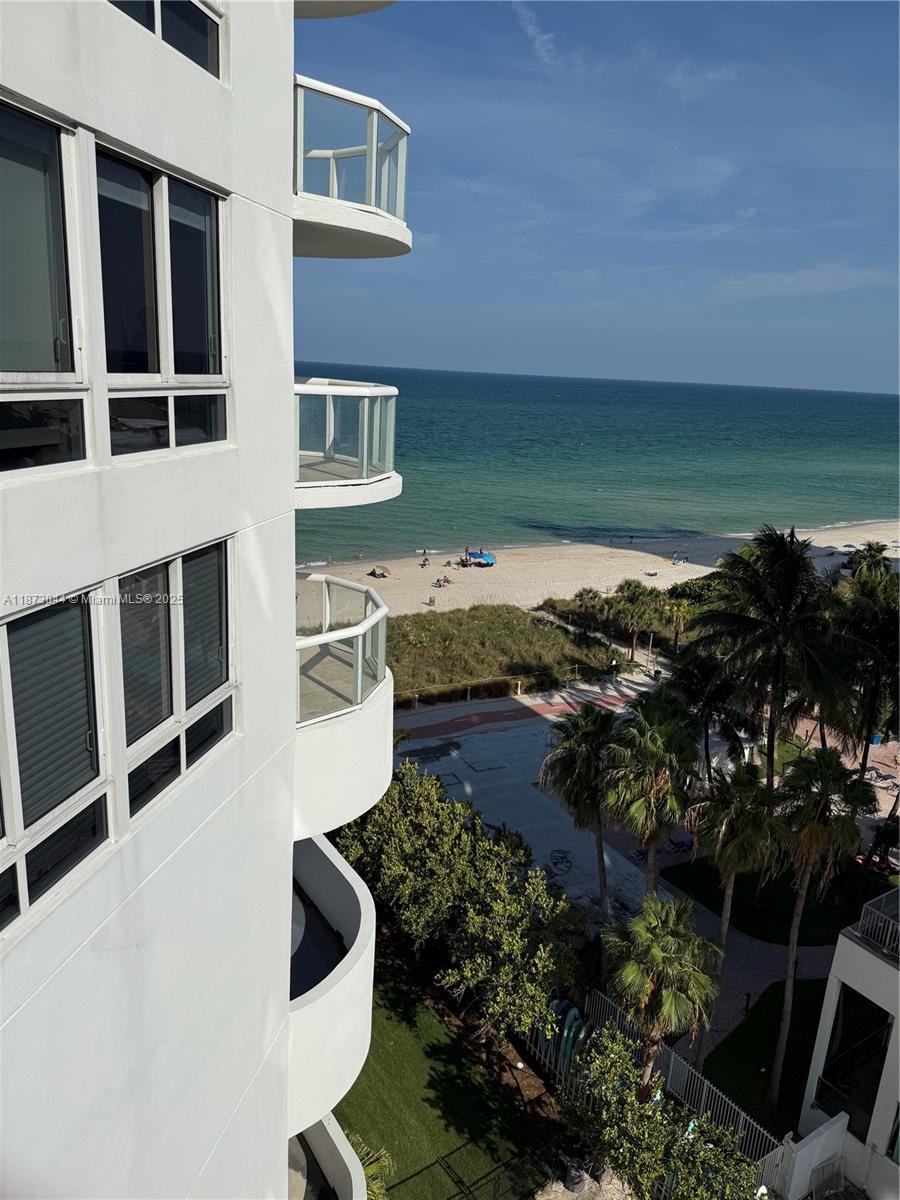 6365 Collins Avenue, Unit 904 Miami Beach, FL 33141 - Photo 9 of 25 a balcony with table and chairs