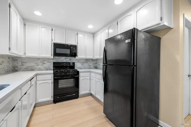 a kitchen with a refrigerator stove and microwave