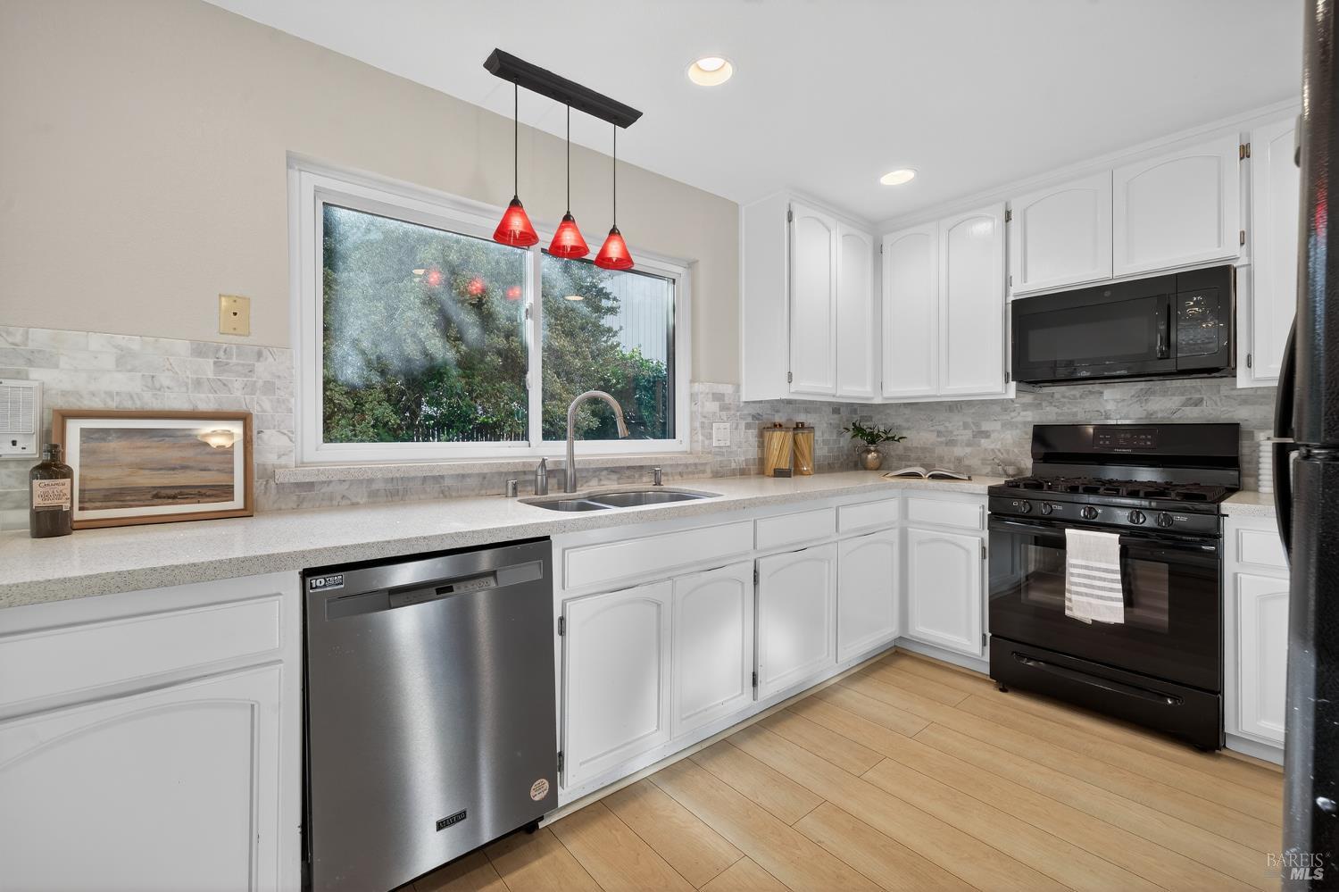 985 Hacienda Circle Rohnert Park, CA 94928 - Photo 9 of 36 a kitchen with a sink stove top oven and microwave