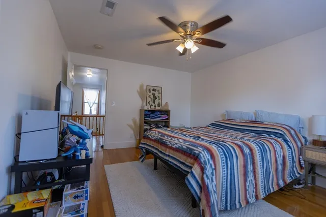 a bedroom with bed and a chandelier