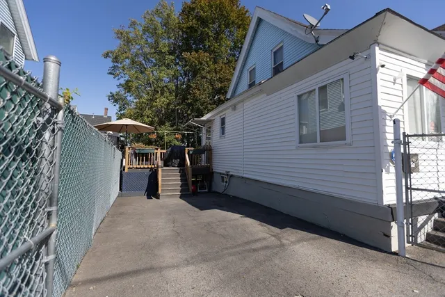 a view of a house with backyard and sitting area