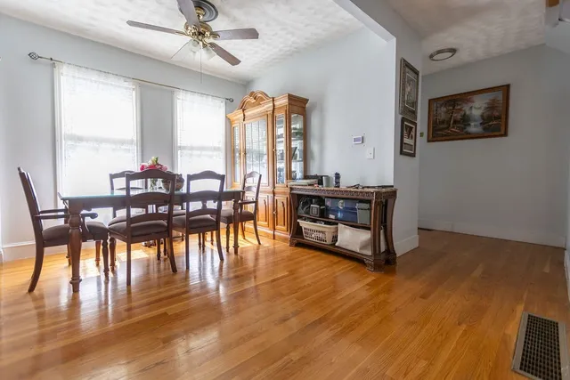 a view of a dining room with furniture window and wooden floor