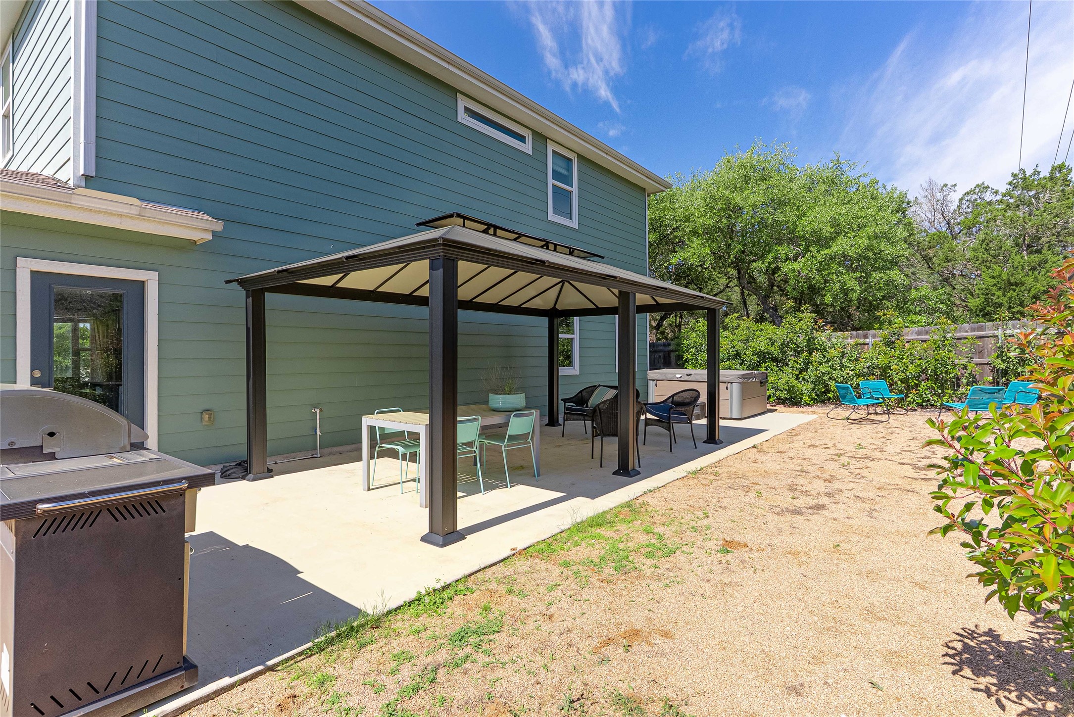 410 Summit Ridge Drive North Point Venture, TX 78645 - Photo 25 of 37 a patio with a table and chairs under an umbrella