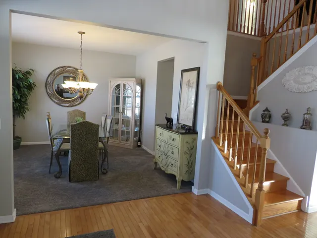 a view of a dining room and hall with wooden floor