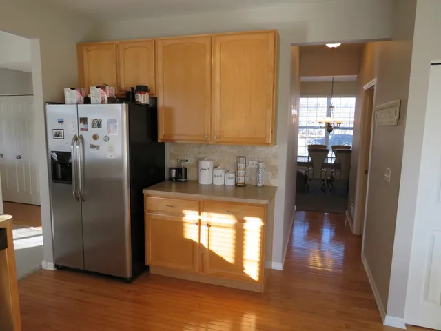 a kitchen with stainless steel appliances granite countertop a refrigerator and a sink