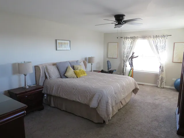 a spacious bedroom with a bed and a window