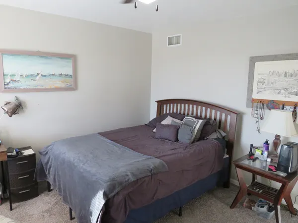 a bedroom with a bed and a window