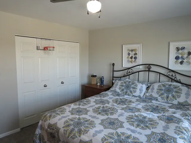 a bedroom with a bed and a chandelier