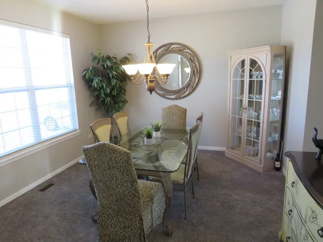 a dining room with furniture and a mirror