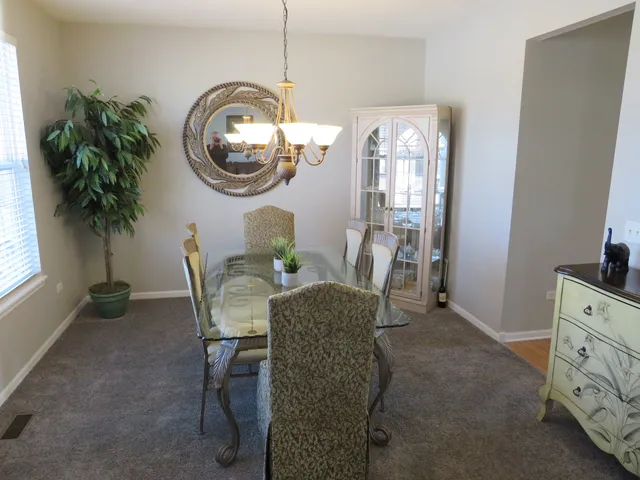 a dining room with furniture and a mirror