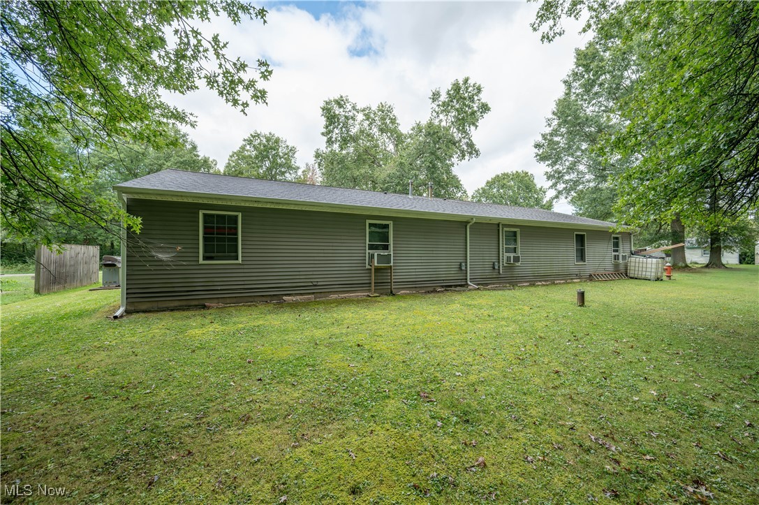 5546 Shaffer Road Northwest, Unit A & B Warren, OH 44481 - Photo 45 of 47 Rear view of property featuring a yard and cooling unit