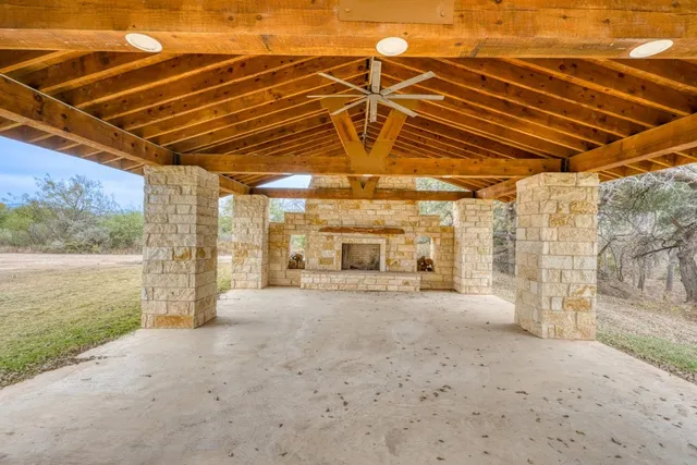 a view of a yard with wooden fence