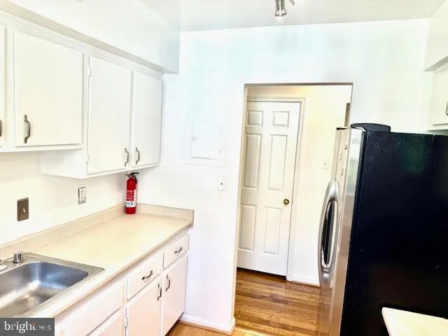 a kitchen with a sink and a refrigerator
