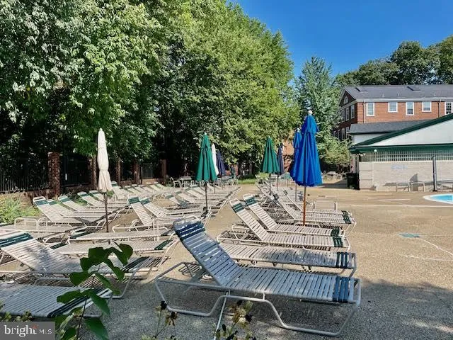 a view of a chair and tables in the backyard of the house