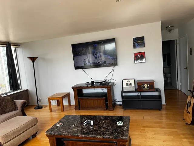 a living room with furniture and a flat screen tv