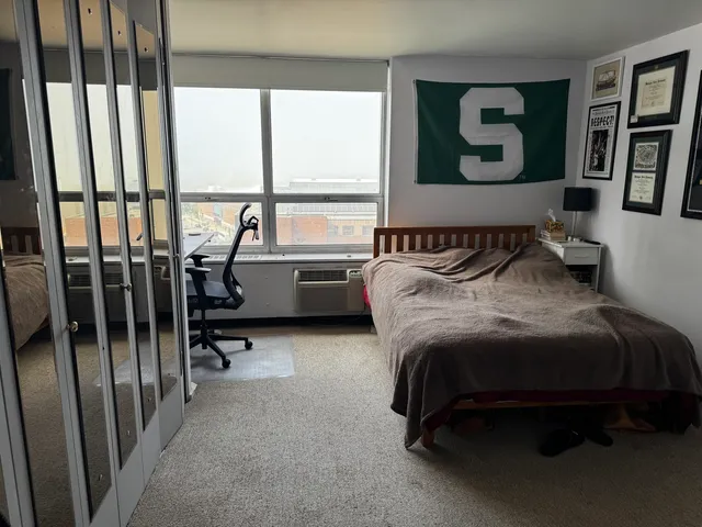 a bedroom with furniture and a window