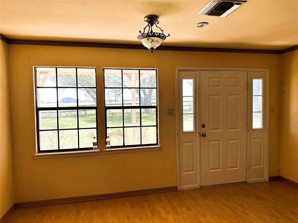 20136 Longstreet Road Richards, TX 77873 - Photo 24 of 50 a view of empty room with wooden floor and fan