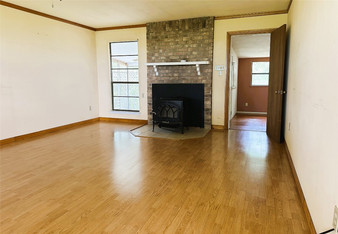 20136 Longstreet Road Richards, TX 77873 - Photo 26 of 50 a view of an empty room with wooden floor and a fireplace