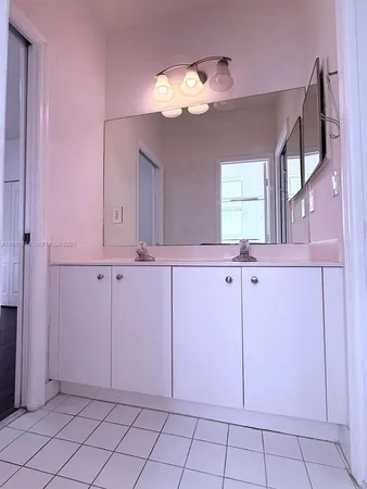 a view of a hallway to closet and a mirror