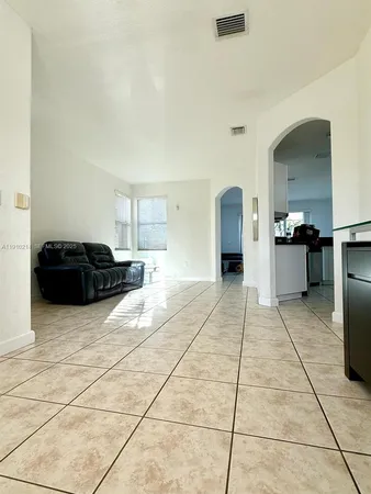 a living room with a black white checkered floor