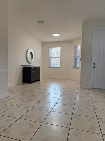 a view of a livingroom with wooden floor and window