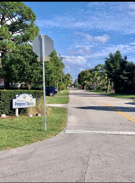 1301 Southeast 22nd Avenue, Unit 4 Pompano Beach, FL 33062 - Photo 14 of 14 a view of a garden with a bench