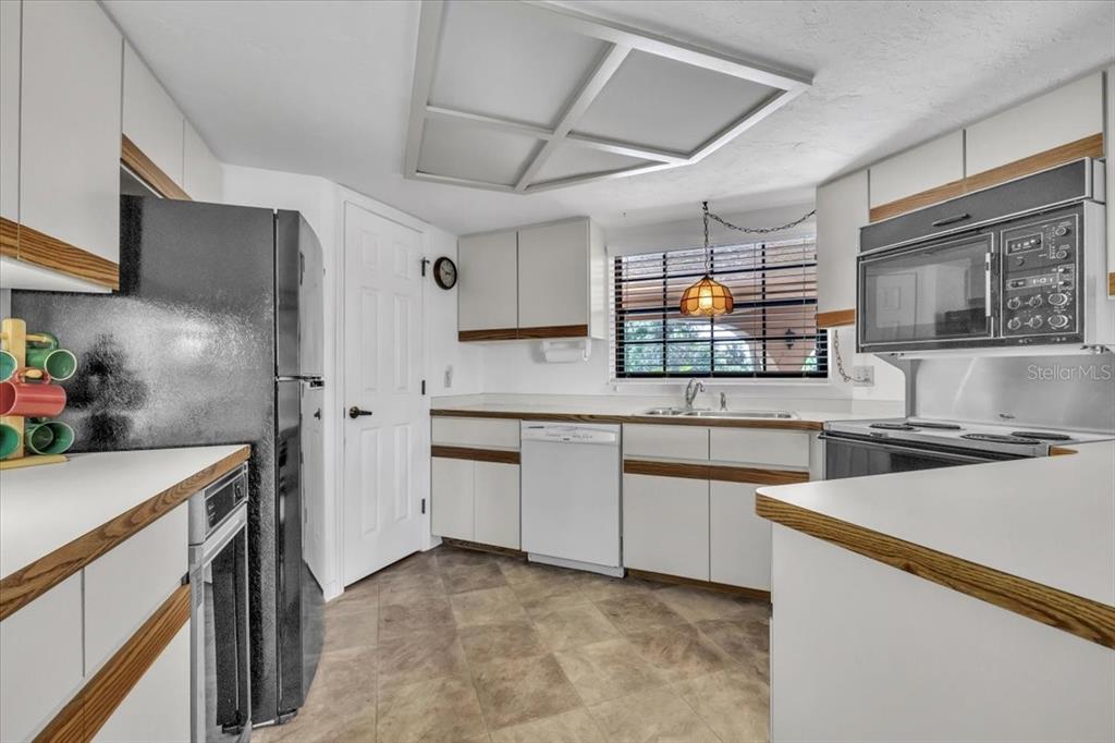23465 Harbor View Road, Unit 723 Port Charlotte, FL 33980 - Photo 12 of 42 a kitchen with granite countertop cabinets stainless steel appliances and a counter space