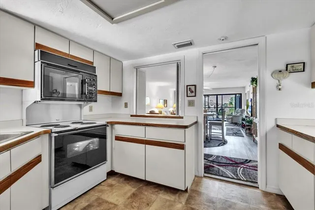 a kitchen with stainless steel appliances granite countertop a sink and a stove